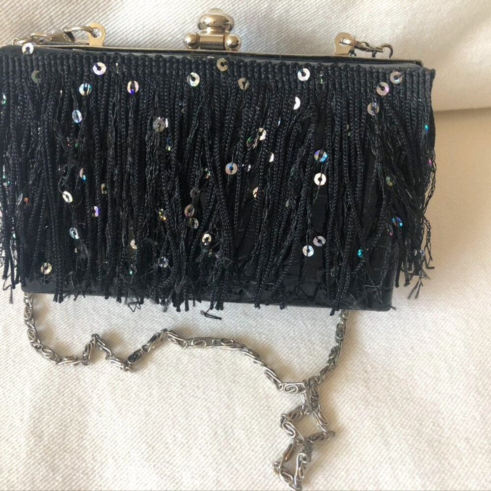 Black patent leather clutch trimmed with sequined fringe.